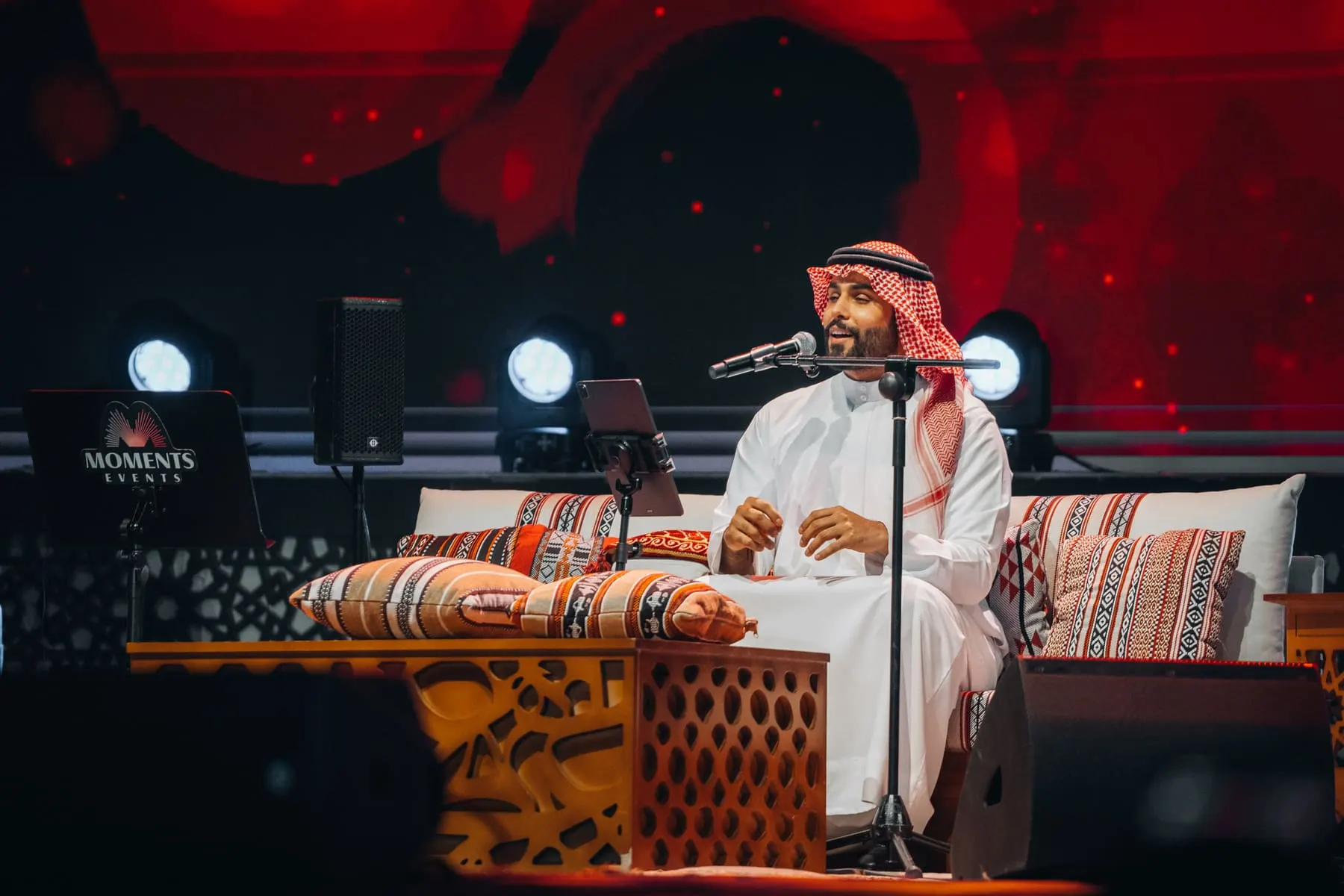 Singer performing seated on the festival stage — Mahmod Al Turky & Yara — live in Abu Dhabi, Sheikh Zayed Festival — Agency Verse