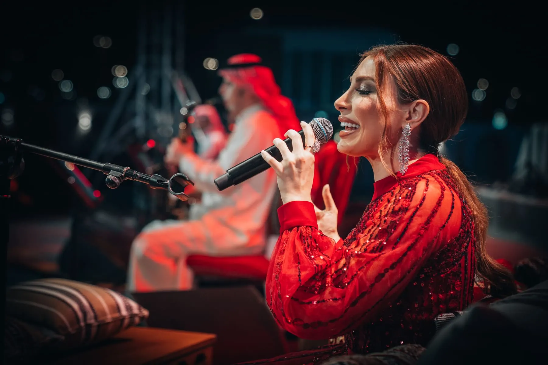 Singer in red performing on stage — Mahmod Al Turky & Yara — live in Abu Dhabi, Sheikh Zayed Festival — Agency Verse