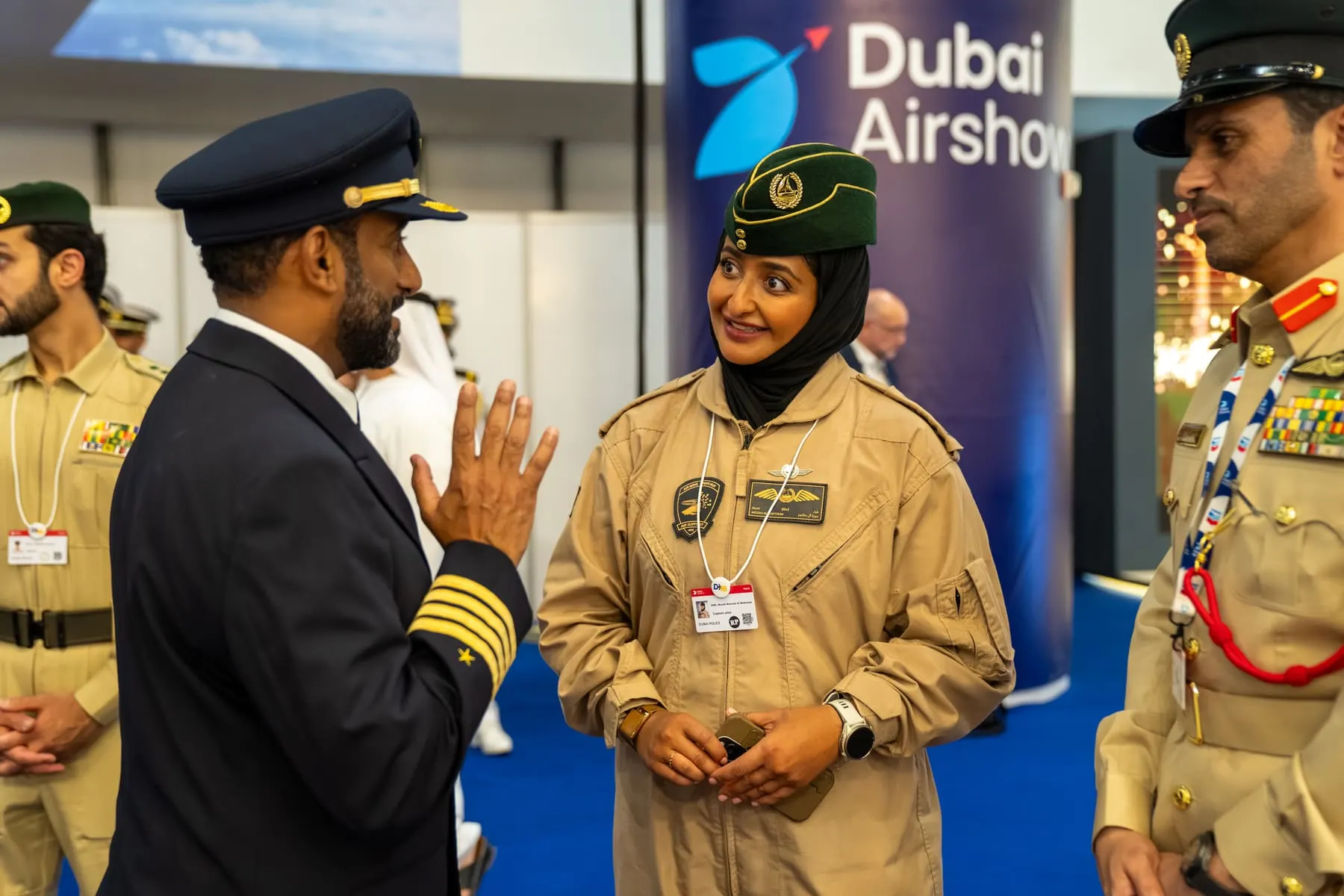 Sheikha Mozah in her flight suit talking with a pilot — Sheikha Mozah — Dubai Airshow 2025 — Agency Verse