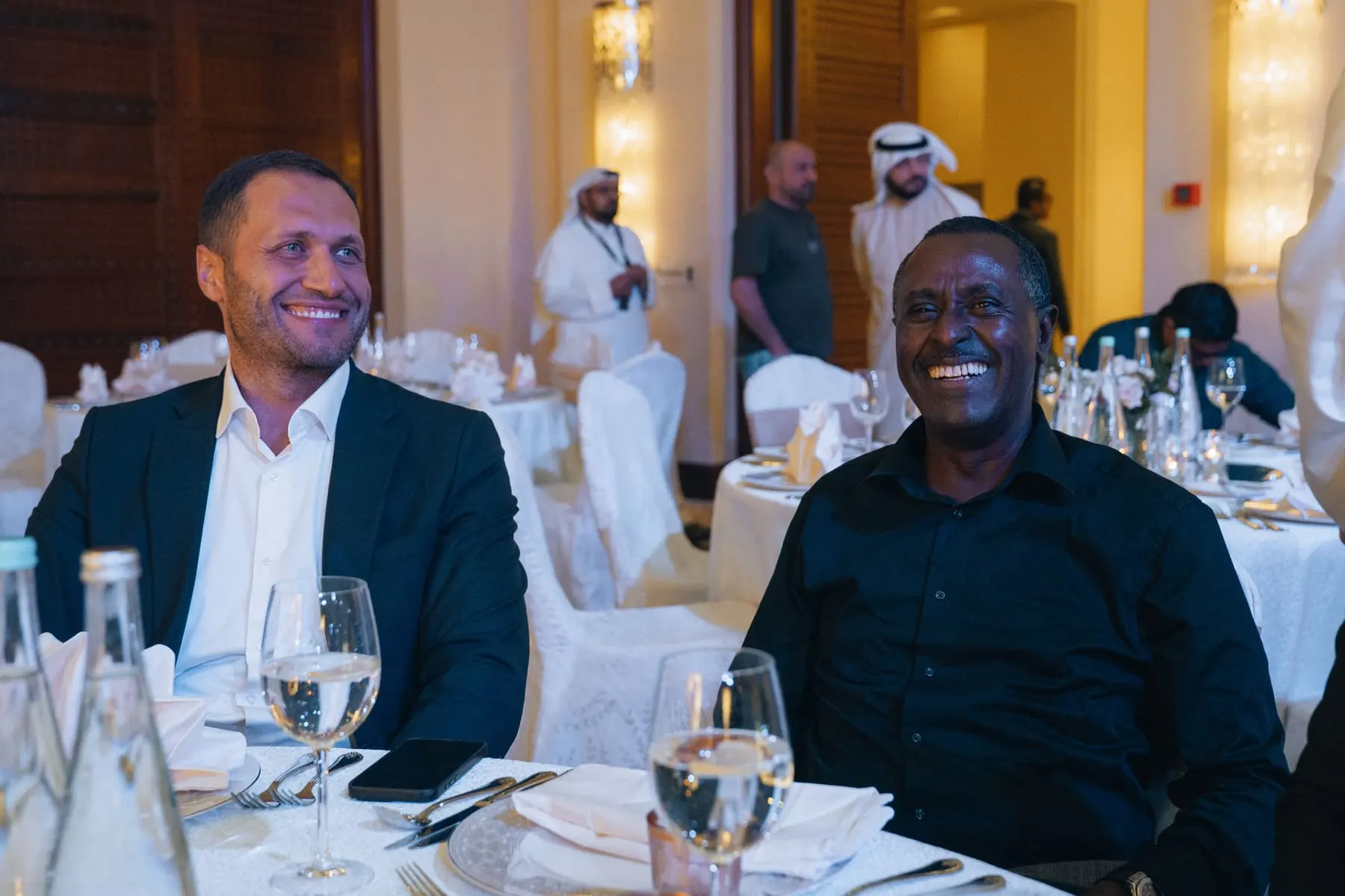 Launch-event coverage — Smiling guests at a dinner table during the evening — Al Matiya Investment × FC Barcelona — Agency Verse