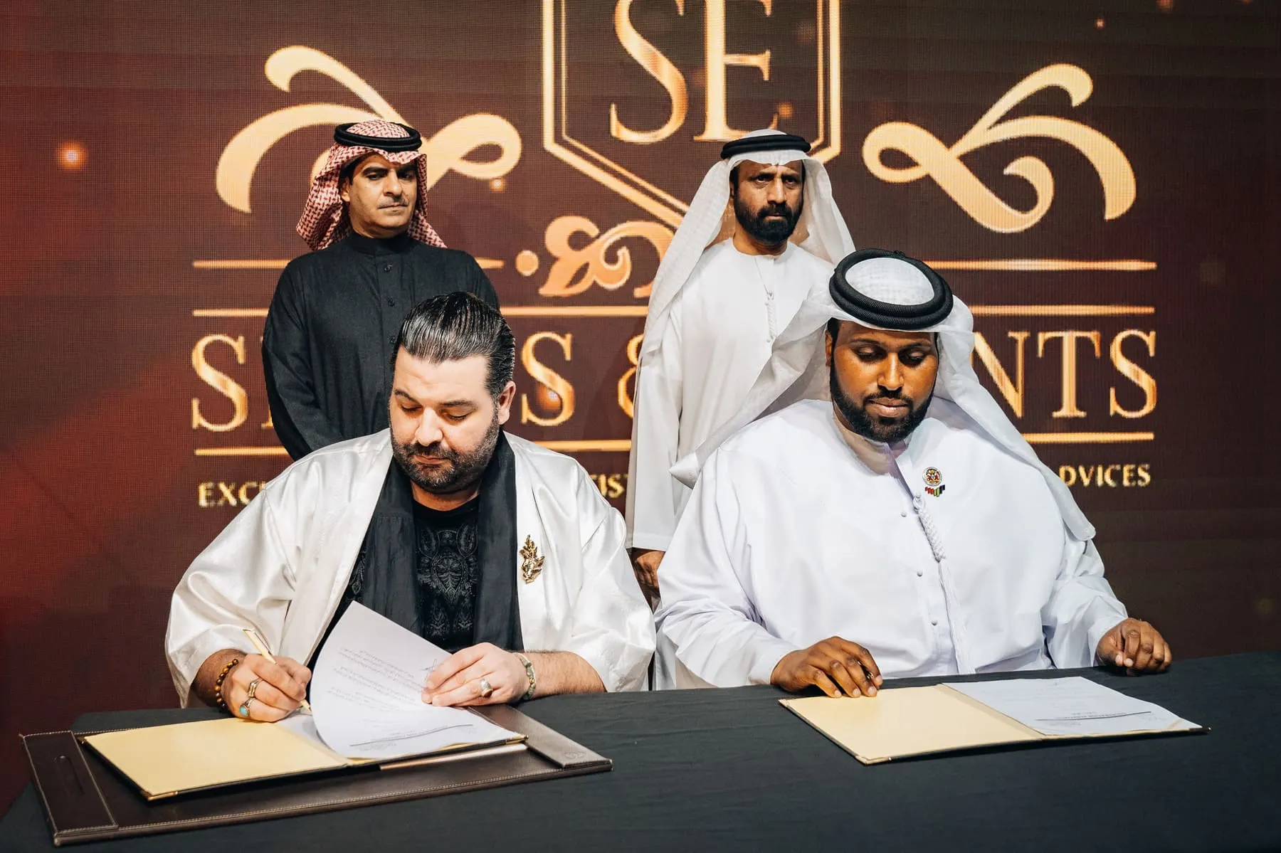 Signing ceremony at the table — Al Matiya Investment × FC Barcelona — Agency Verse
