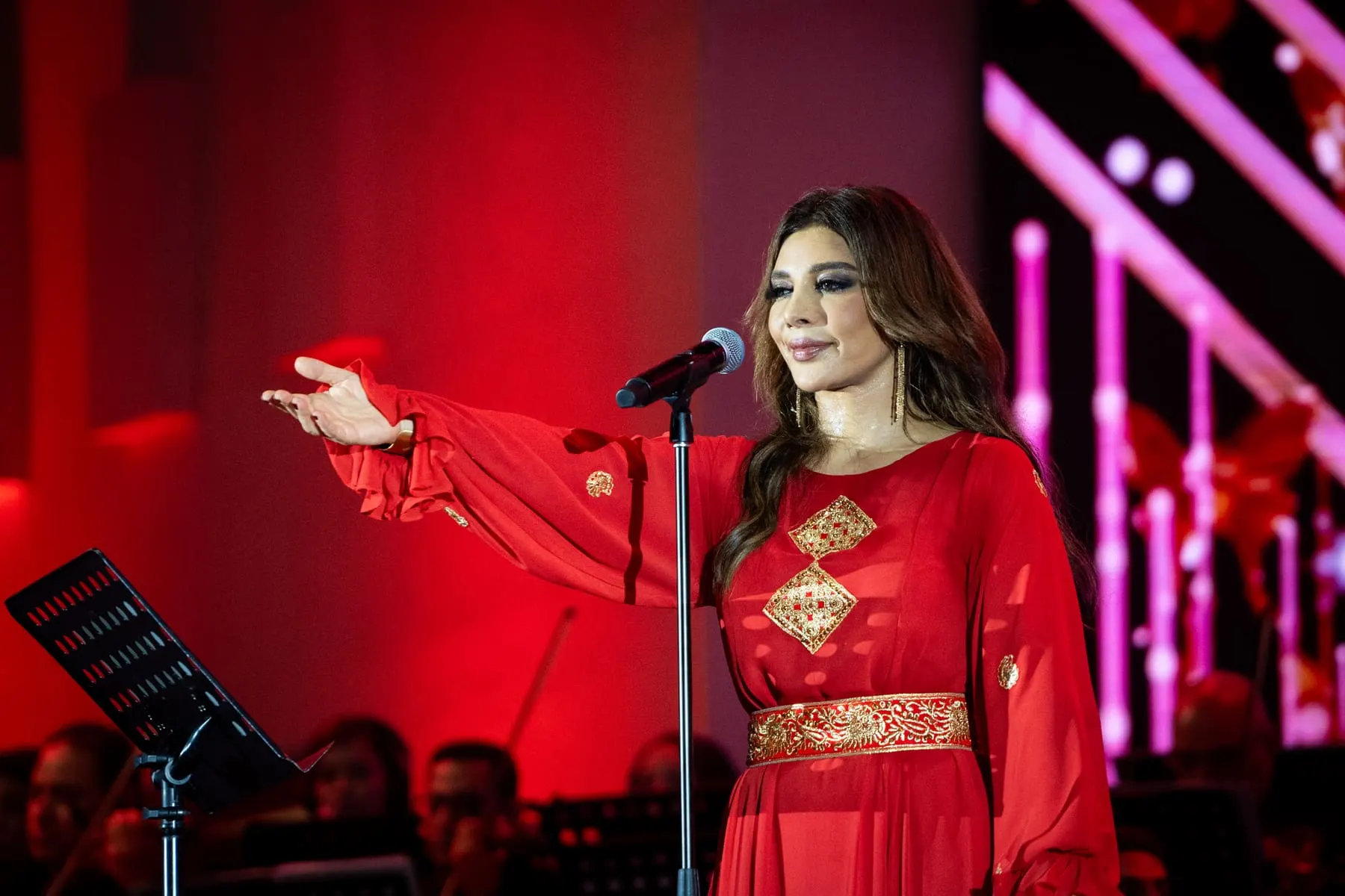 Singer in red on stage — Assala — live at Sheikh Zayed Festival, Abu Dhabi — Agency Verse