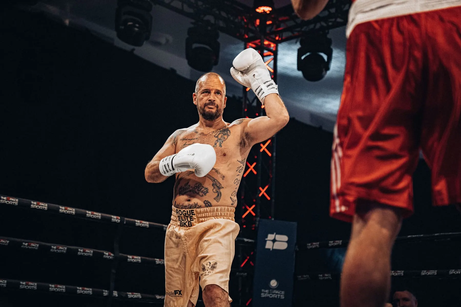Boxer celebrating with a raised glove in the ring — Big Bang Boxing, Dubai — Agency Verse
