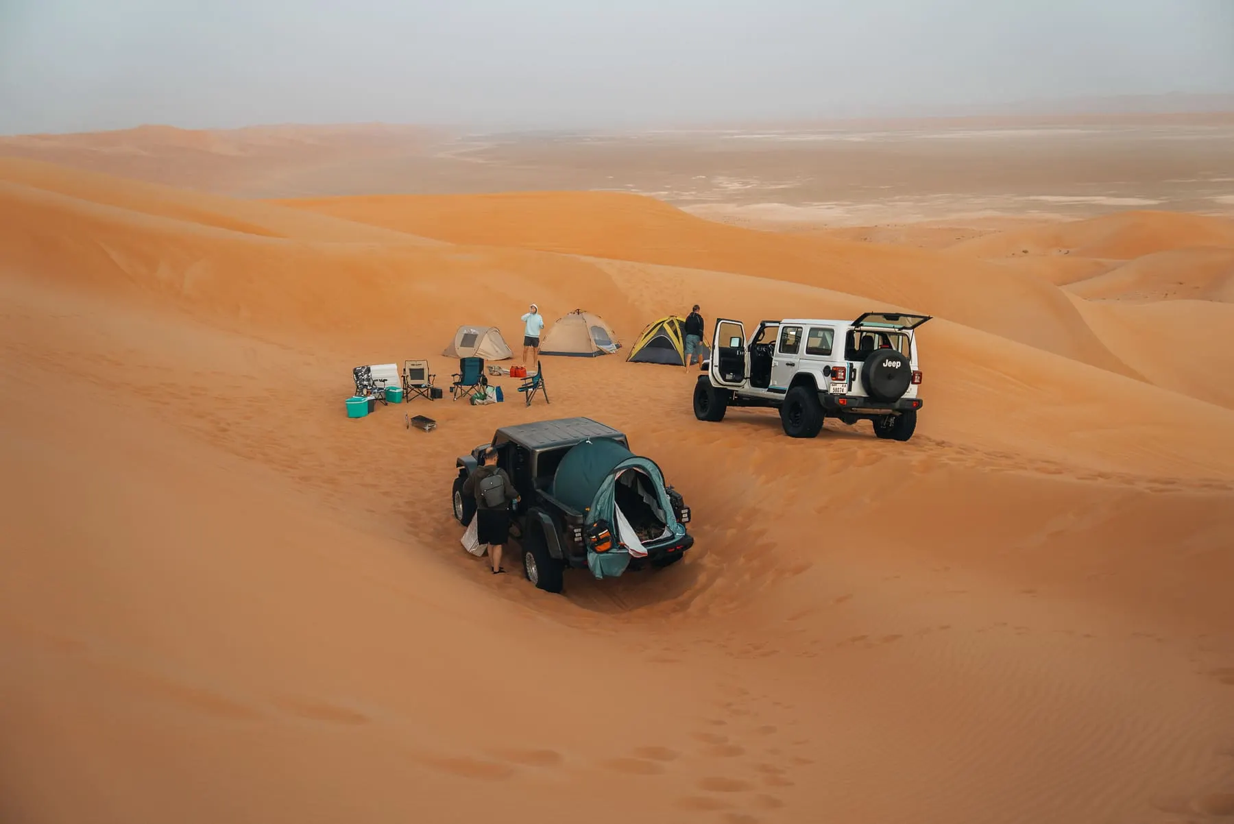 Brand Film — Aerial view of 4x4 vehicles and a camp on red desert dunes — Deep Desert Experience, Dubai desert — Agency Verse
