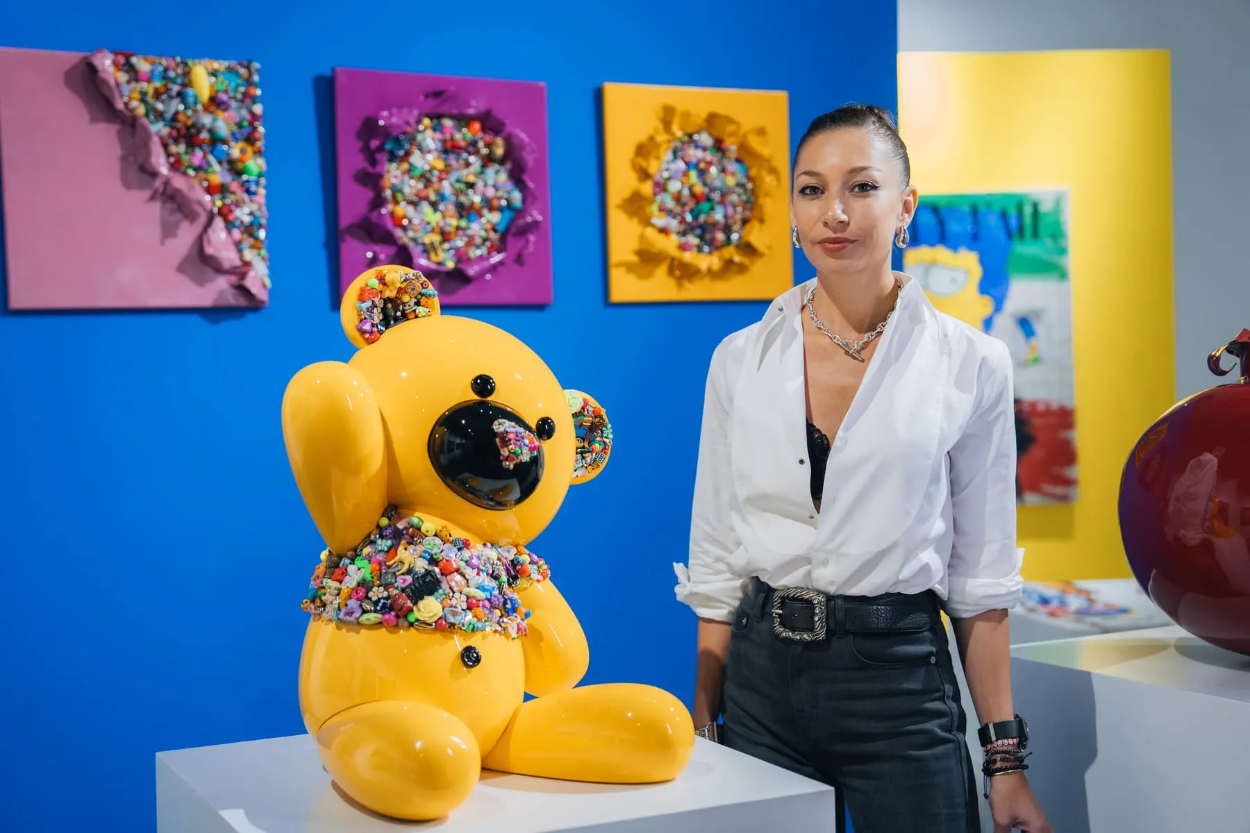 Guest beside a jewelled teddy-bear sculpture — Firetti Art, Dubai — Agency Verse