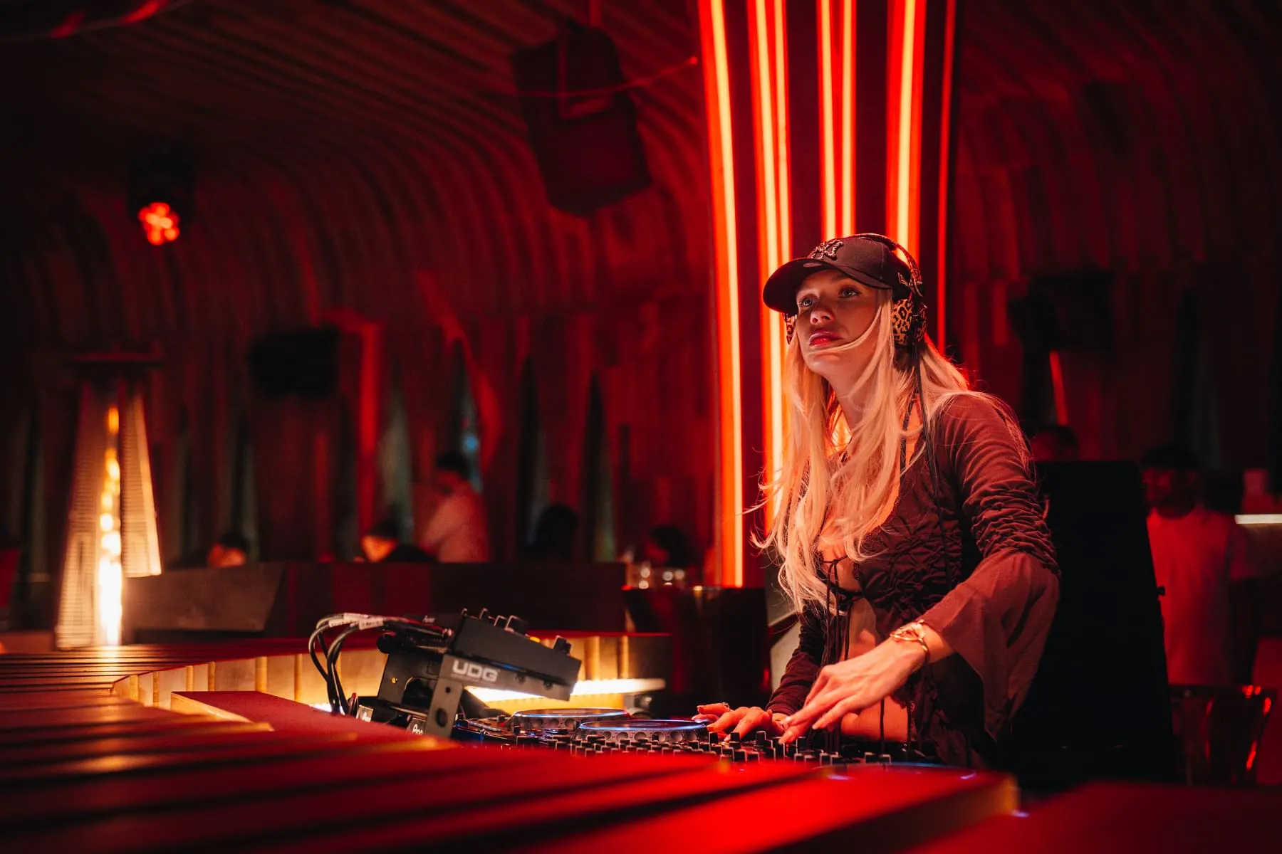 DJ playing beneath red arched light installations — FIVE Bohemia — Rossi, Dubai — Agency Verse