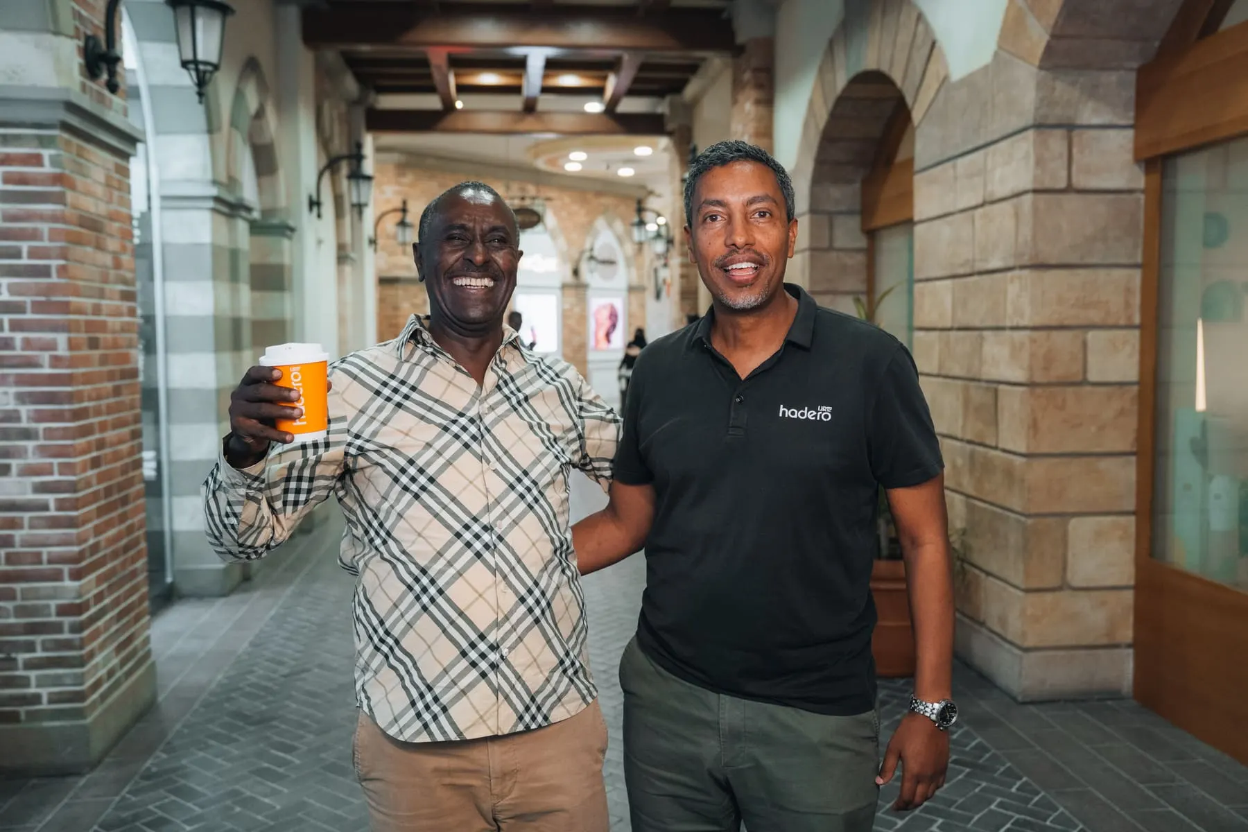 Two men smiling with coffee cups — Hadero Coffee — Agency Verse