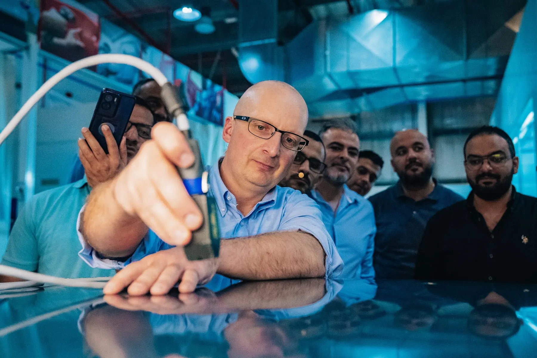 Service explainer videos — Trainer demonstrating a paint spray gun to technicians — Hyundai — Body Repair & Paint Training, Dubai — Agency Verse