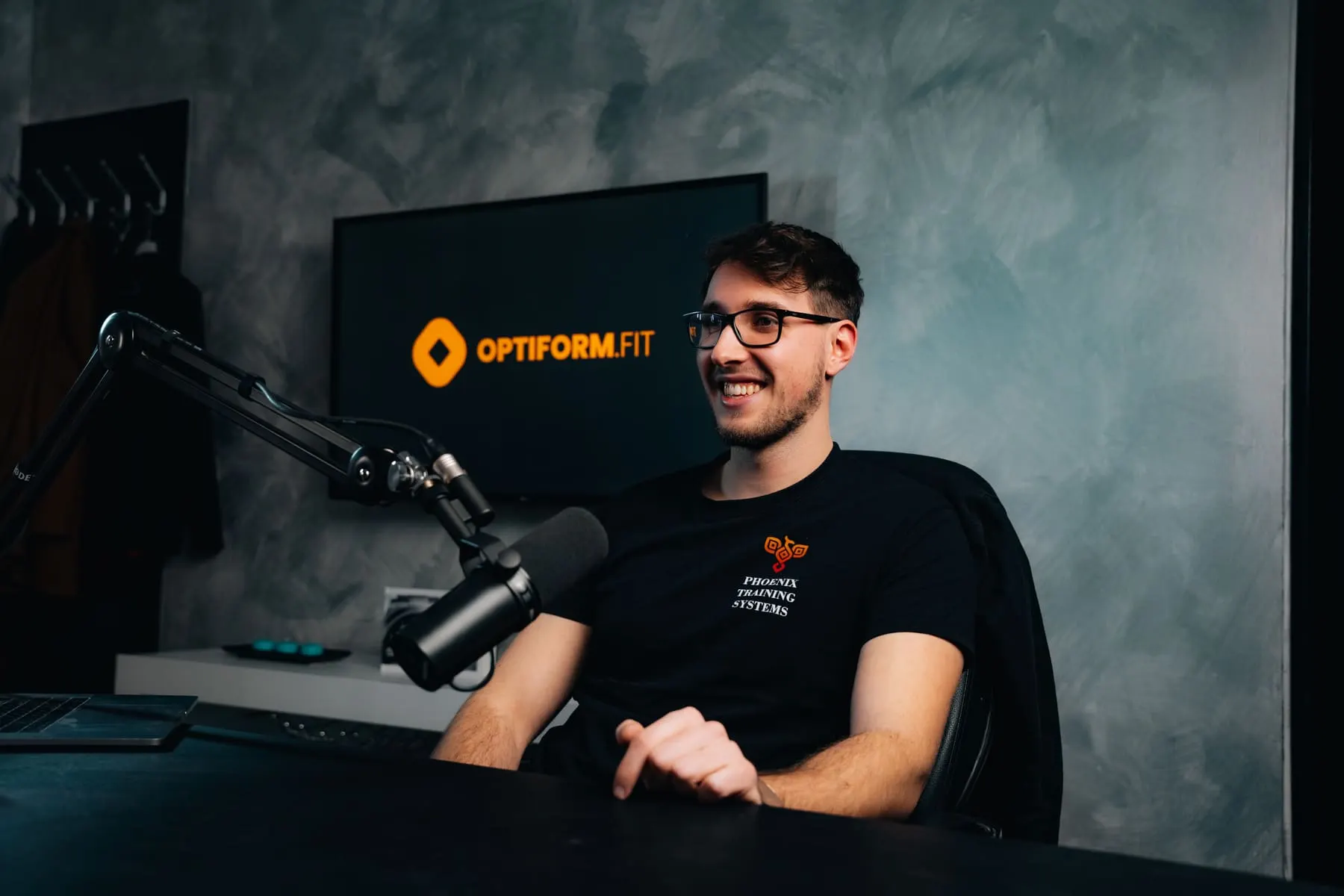 Interview & podcast production — Host recording at a podcast microphone in the studio — OptiForm — Žan Breznikar course, Slovenia — Agency Verse