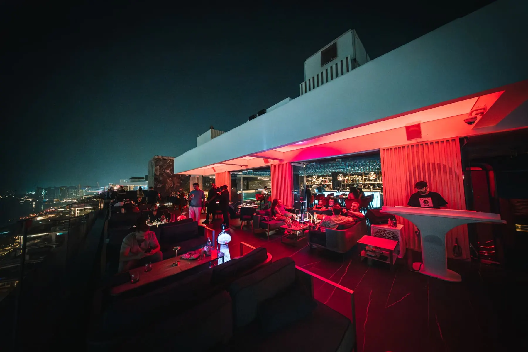 Rooftop terrace lit red at night — The Penthouse, Dubai — Agency Verse