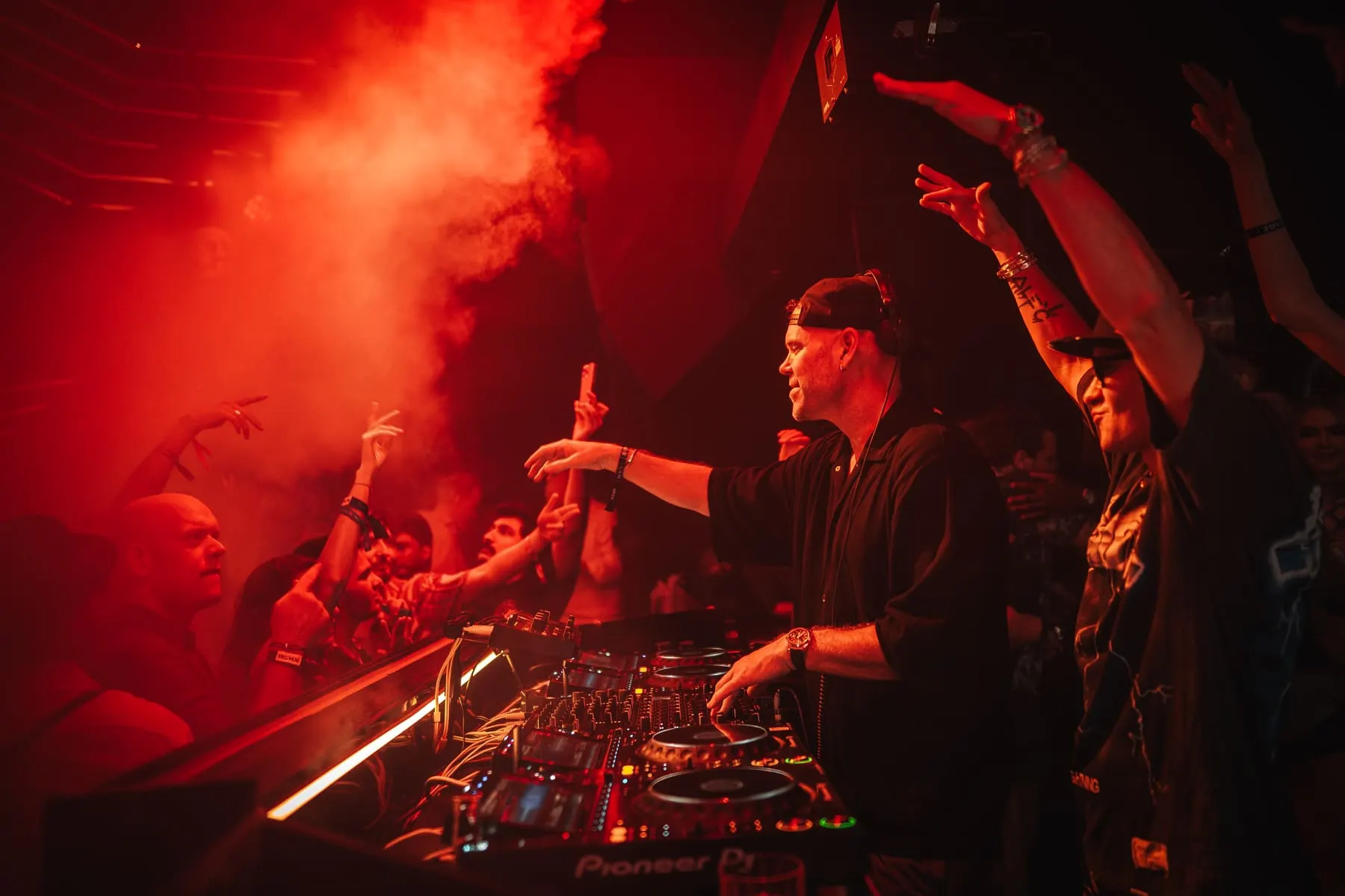 DJs performing to the crowd through red haze — The Penthouse — Solardo b2b Alec Monopoly, Dubai — Agency Verse