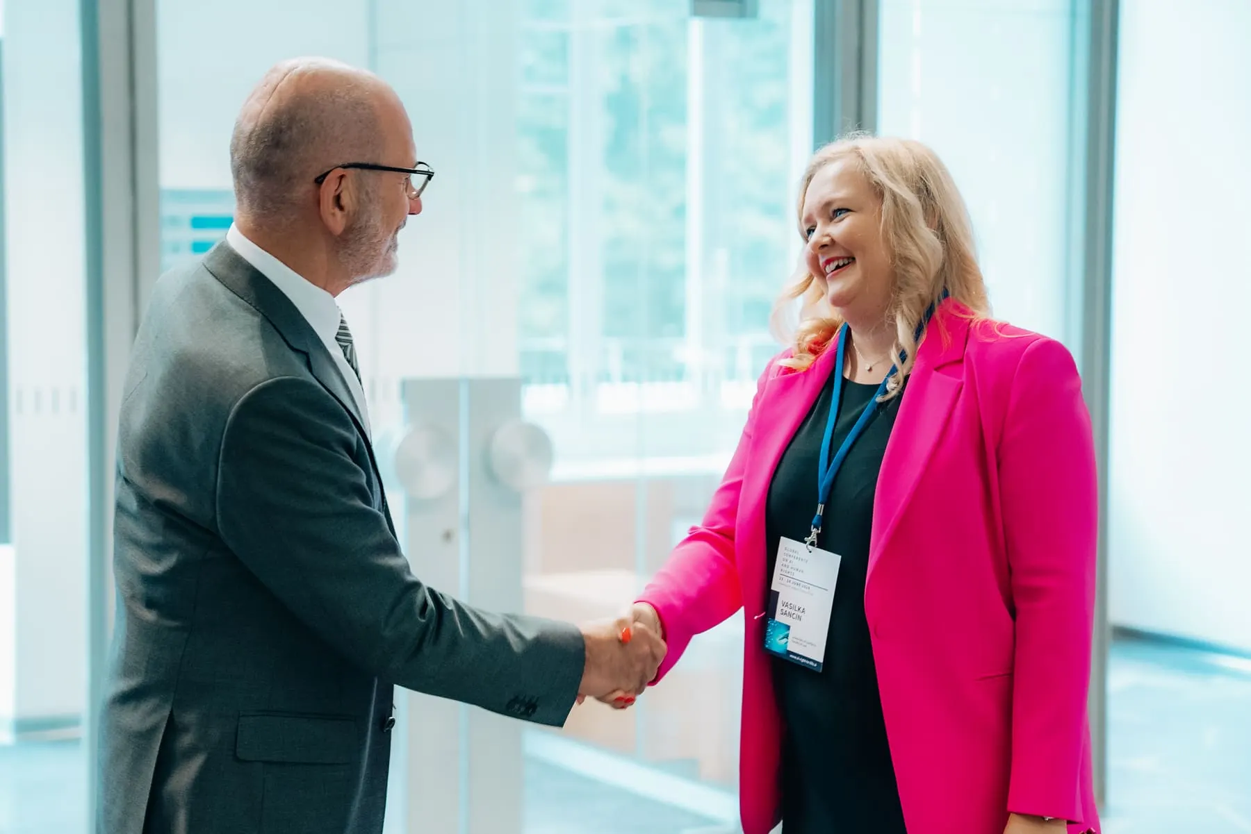 Guests greeting each other at registration — Global Conference on AI & Human Rights — Agency Verse