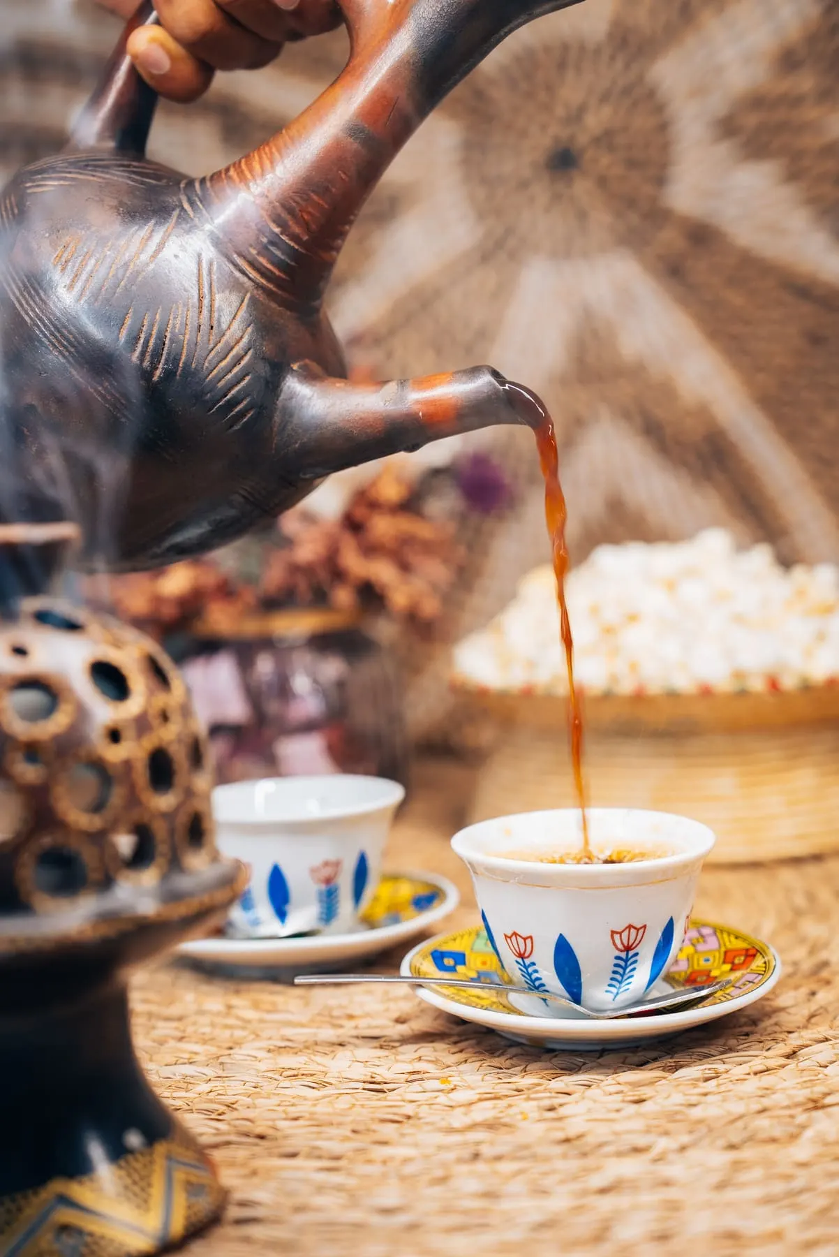 Seasonal campaign content — Coffee being poured during a traditional coffee ceremony — Sara Lemma — Agency Verse