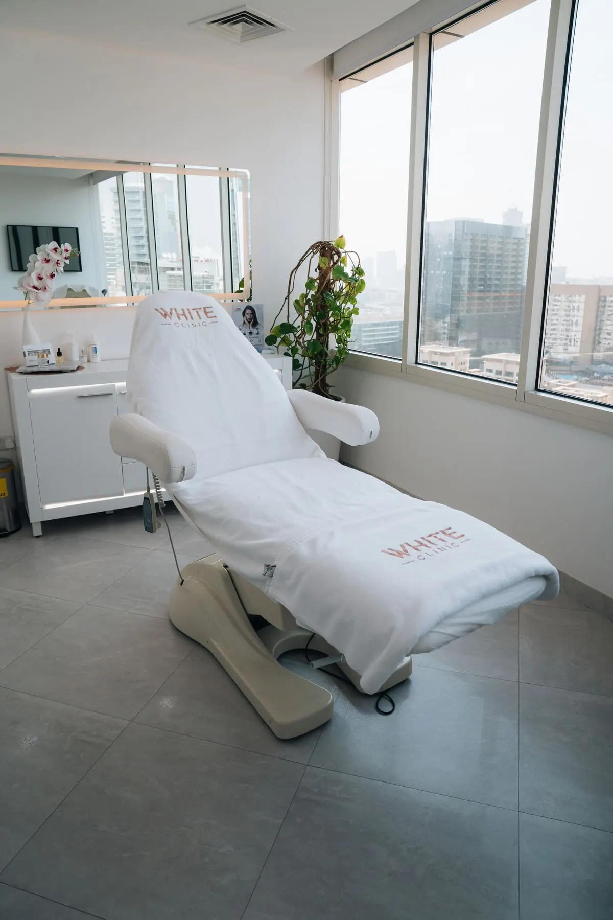Clinic space and detail photography — Treatment room with a white treatment bed — White Clinic, Dubai — Agency Verse